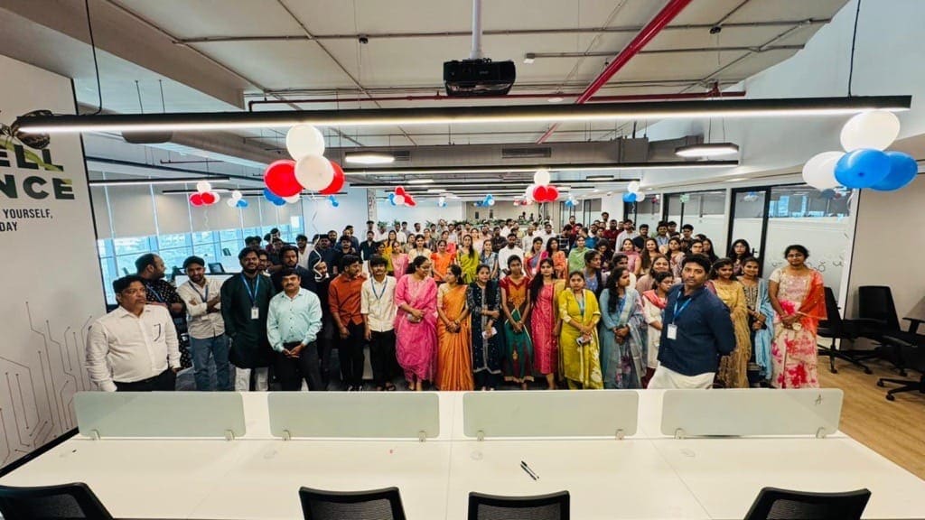 The whole office floor gathered together under red, white and blue balloons